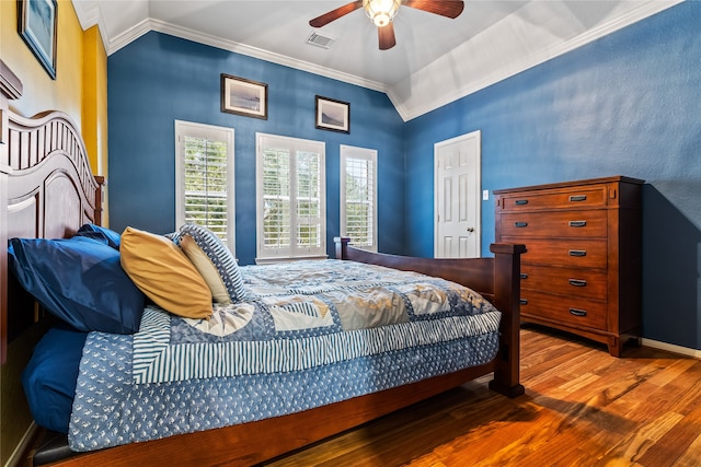 bedroom featuring wood-type flooring, vaulted ceiling, ceiling fan, and ornamental molding