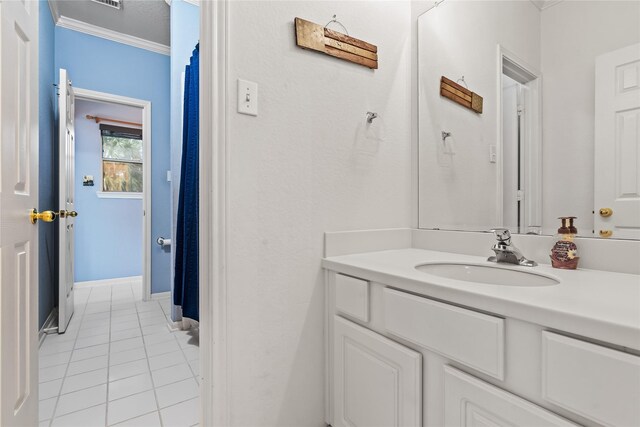 bathroom with vanity, tile patterned floors, and crown molding