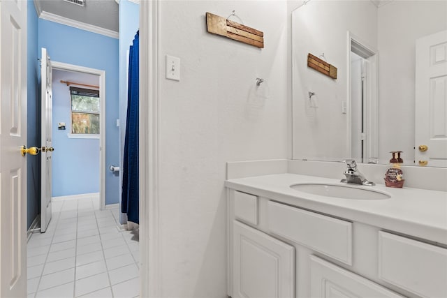 bathroom featuring ornamental molding, vanity, and tile patterned floors