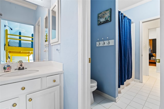 bathroom featuring toilet, vanity, tile patterned floors, and ornamental molding