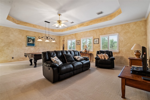 living room featuring light carpet, a raised ceiling, ceiling fan, and crown molding