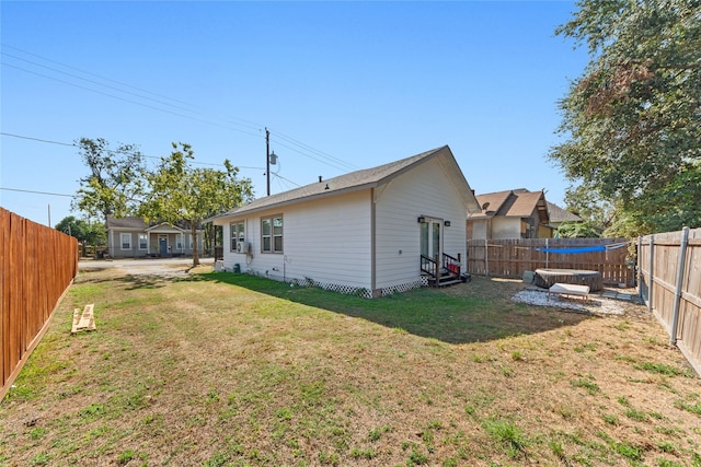 rear view of house featuring a lawn