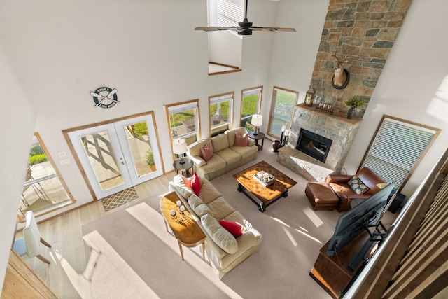 172 Little Dove, Livingston, TX 77351 - living room featuring a high ceiling, healthy amount of natural light, a fireplace, french doors, and wood finished floors