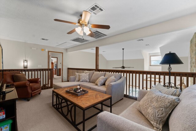 living room featuring ceiling fan, light carpet, and vaulted ceiling