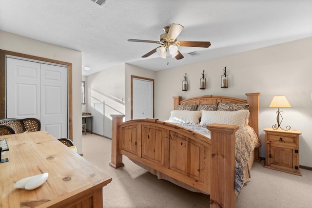 172 Little Dove, Livingston, TX 77351 - bedroom with light colored carpet, a ceiling fan, and two closets