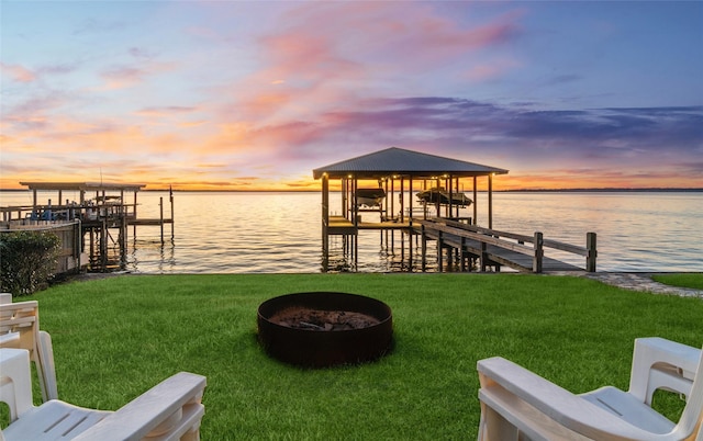 172 Little Dove, Livingston, TX 77351 - dock area with boat lift, a yard, and a water view