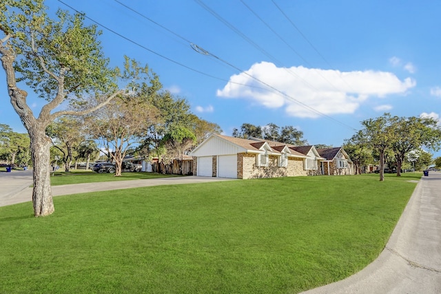 view of front of property with a garage and a front lawn