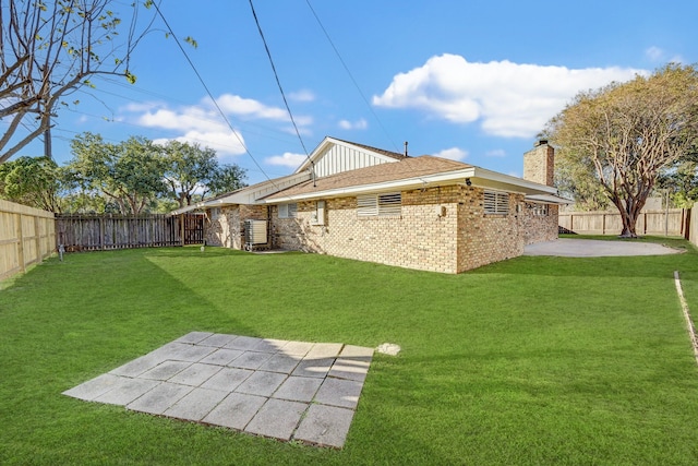 back of property featuring a patio area and a lawn