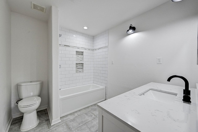 full bathroom with tiled shower / bath, vanity, and toilet