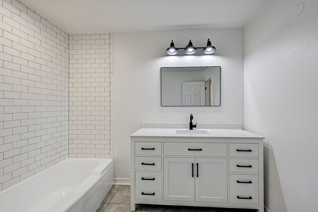 bathroom featuring tile patterned flooring, vanity, and tiled shower / bath combo