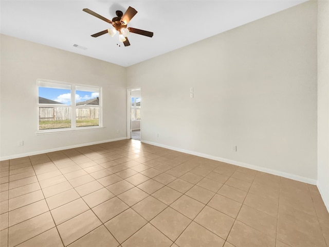 spare room featuring ceiling fan and light tile patterned floors