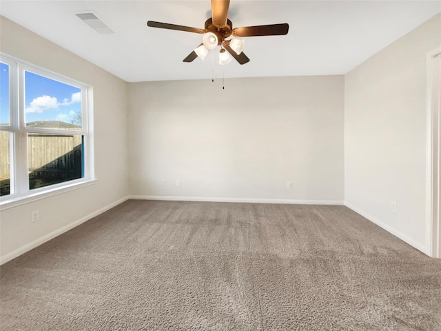 carpeted empty room featuring ceiling fan