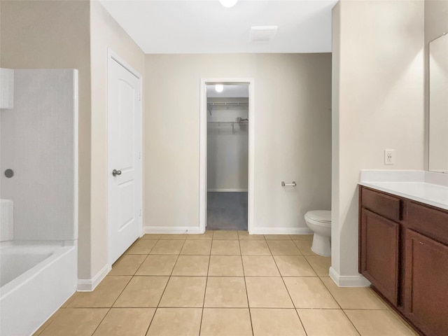 5122 Breezy Parke Ln, Rosenberg, TX 77469 - bathroom with vanity, toilet, tile patterned flooring, baseboards, and a spacious closet