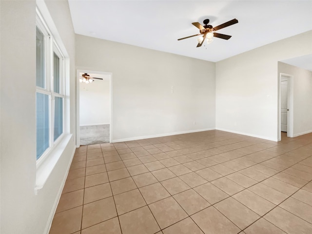 unfurnished room with ceiling fan and light tile patterned floors