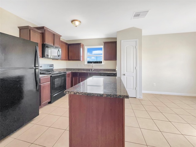 5122 Breezy Parke Ln, Rosenberg, TX 77469 - kitchen with black appliances, light tile patterned floors, a sink, dark stone counters, and a center island