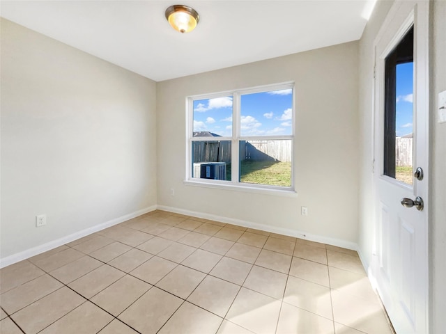 5122 Breezy Parke Ln, Rosenberg, TX 77469 - unfurnished room with healthy amount of natural light, light tile patterned floors, and baseboards