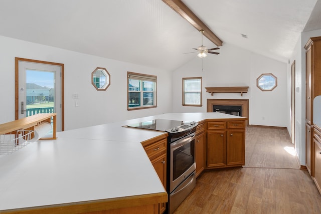 kitchen with electric range, lofted ceiling with beams, light hardwood / wood-style flooring, and ceiling fan