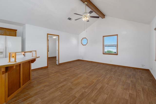 unfurnished living room featuring vaulted ceiling with beams, ceiling fan, and hardwood / wood-style flooring