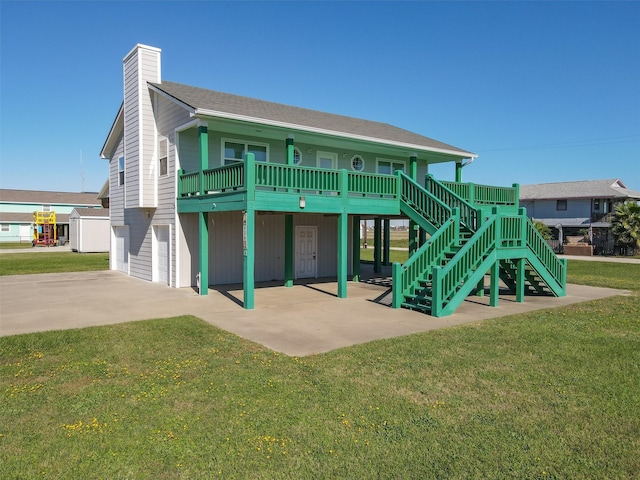 view of playground with a lawn, a patio area, and a deck