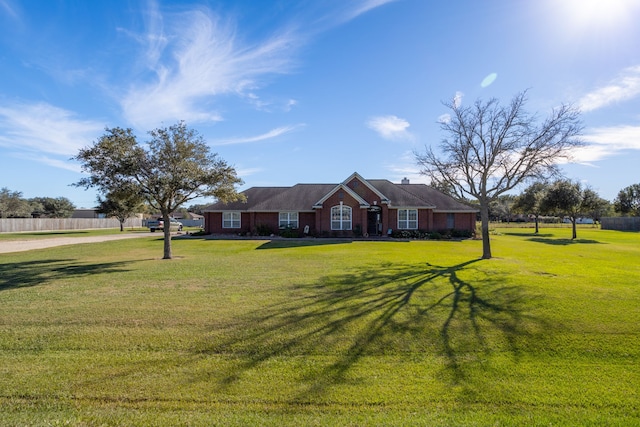 ranch-style home with a front lawn