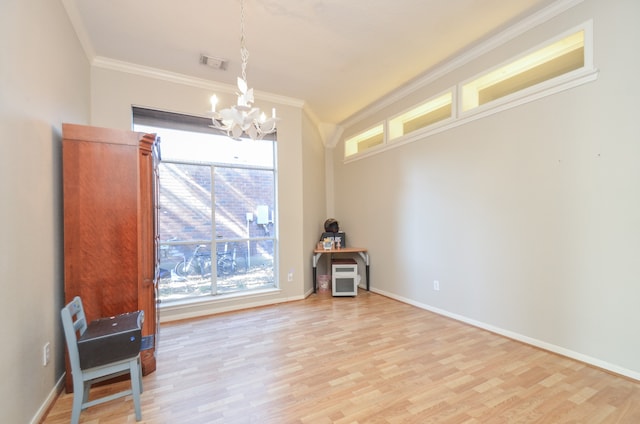 interior space with a wealth of natural light, crown molding, light hardwood / wood-style floors, and an inviting chandelier