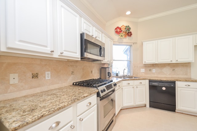 kitchen with tasteful backsplash, white cabinetry, sink, and appliances with stainless steel finishes