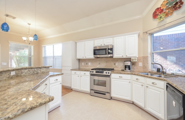 kitchen with white cabinetry, light stone counters, pendant lighting, decorative backsplash, and appliances with stainless steel finishes