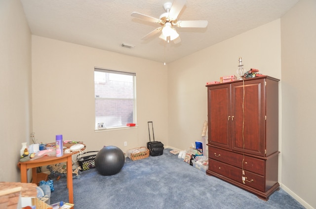 workout room with carpet, a textured ceiling, and ceiling fan