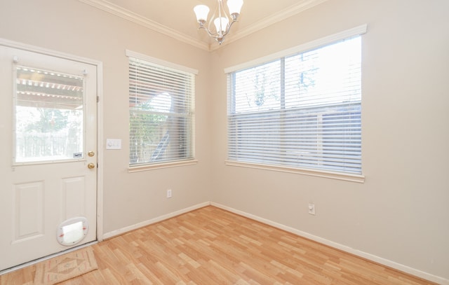 doorway to outside with crown molding, light hardwood / wood-style floors, and a notable chandelier