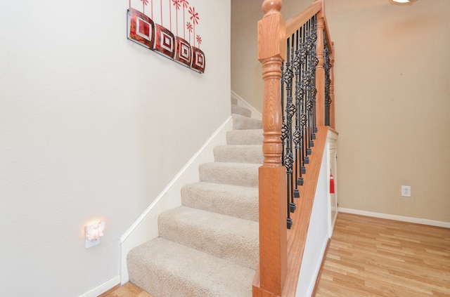 stairway with hardwood / wood-style flooring