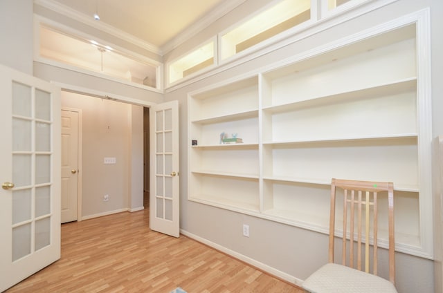 interior space featuring hardwood / wood-style floors, ornamental molding, and french doors