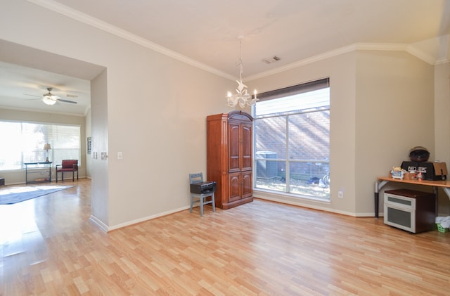 dining area with ceiling fan with notable chandelier, light wood-type flooring, and ornamental molding