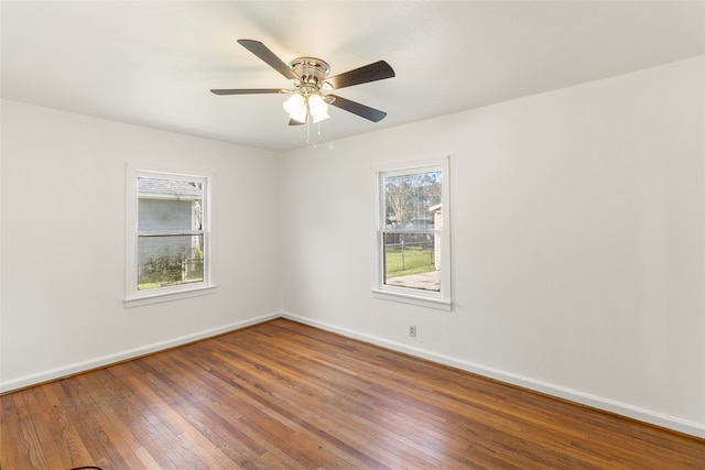 empty room with ceiling fan and wood-type flooring