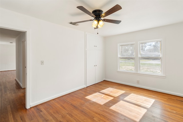 unfurnished room featuring hardwood / wood-style flooring and ceiling fan