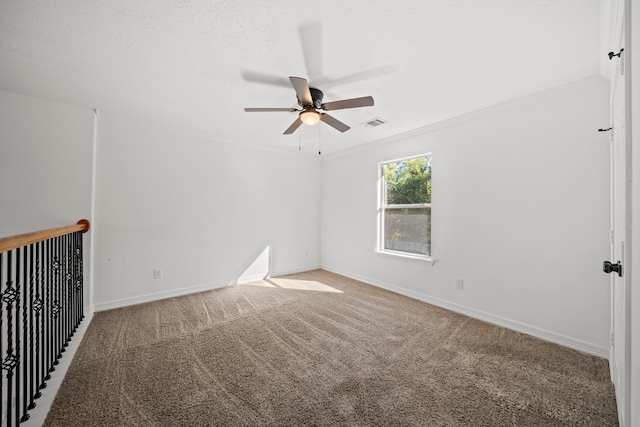 spare room featuring crown molding, carpet, and ceiling fan