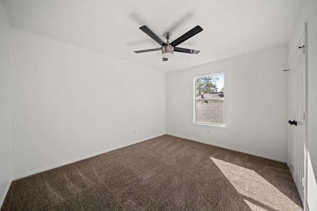 spare room featuring ceiling fan and carpet