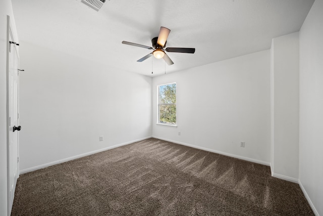 unfurnished room featuring ceiling fan and dark colored carpet