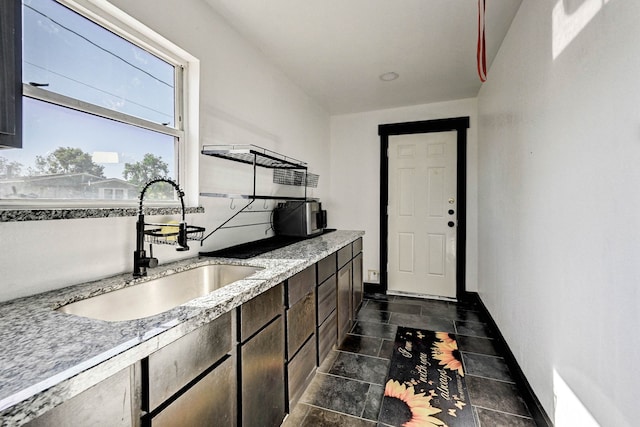 kitchen featuring dark brown cabinetry and sink