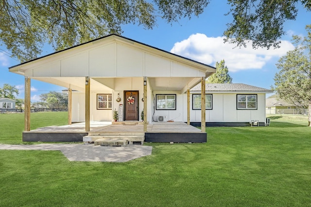 rear view of property featuring a porch and a lawn