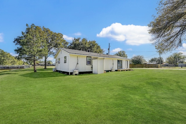 rear view of house featuring a lawn