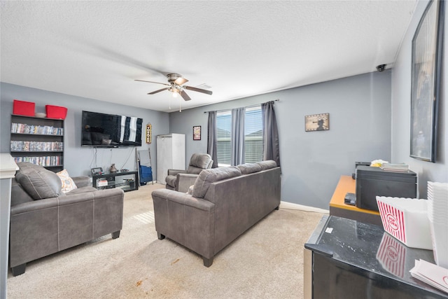 carpeted living room with ceiling fan and a textured ceiling