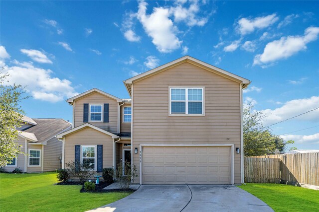 view of property featuring a front yard and a garage