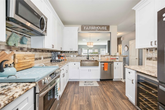 kitchen with wine cooler, white cabinetry, and stainless steel appliances