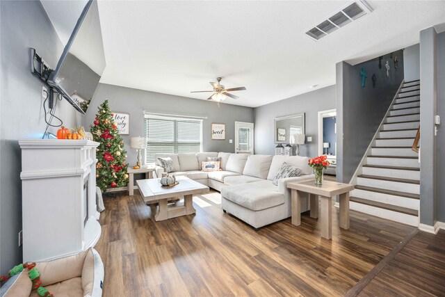 living room featuring dark hardwood / wood-style floors and ceiling fan