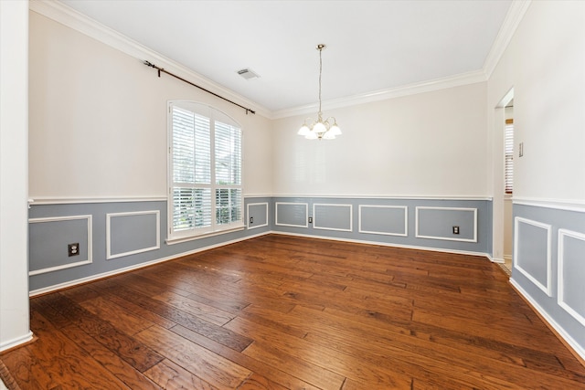 unfurnished room featuring dark hardwood / wood-style floors, an inviting chandelier, and crown molding