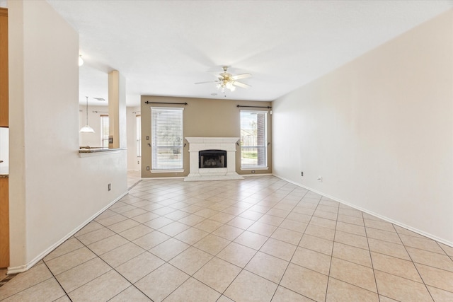 unfurnished living room featuring light tile patterned floors and ceiling fan