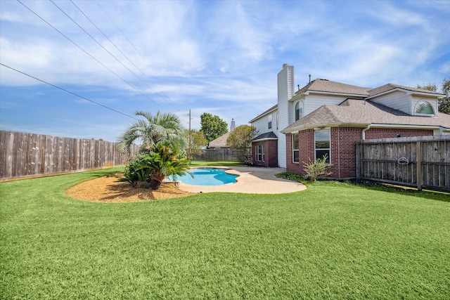 view of yard featuring a fenced in pool and a patio