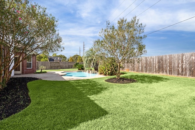 view of yard with a fenced in pool and a patio