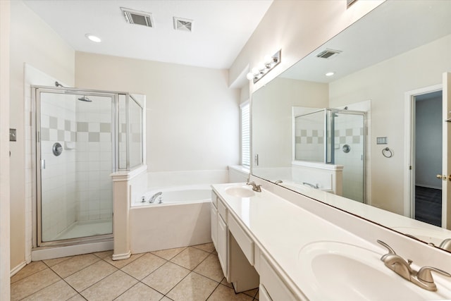 bathroom with tile patterned flooring, vanity, and plus walk in shower