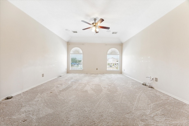 carpeted empty room featuring ceiling fan and vaulted ceiling